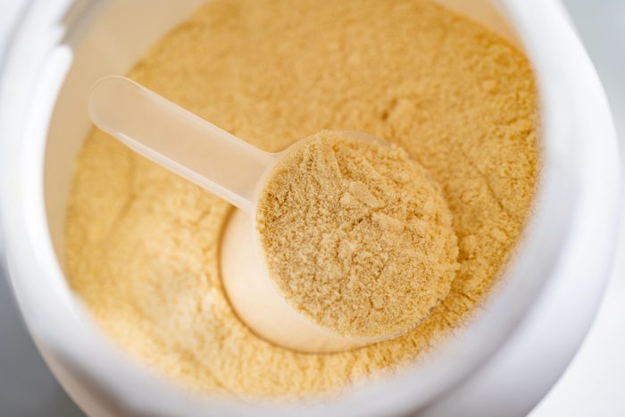 Cup of protein powder in container