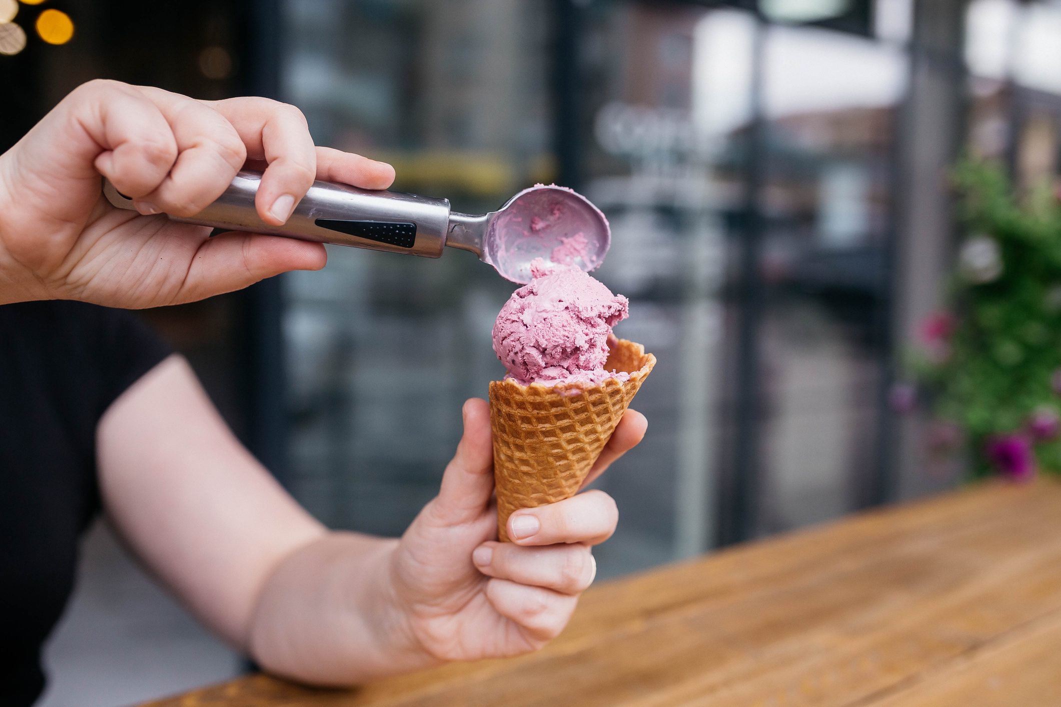 Ice cream cone. Ice cream with waffle cones. Waffle cone being held by a girl. Colorful cereal toppings for vibrance. perfect for hot summer days or winter.