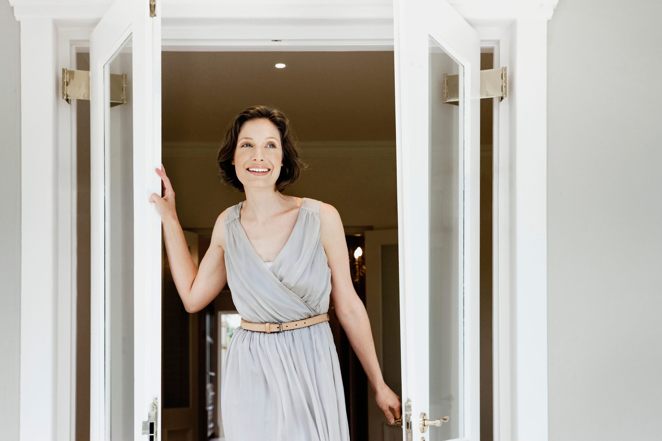 Woman walking through French doors