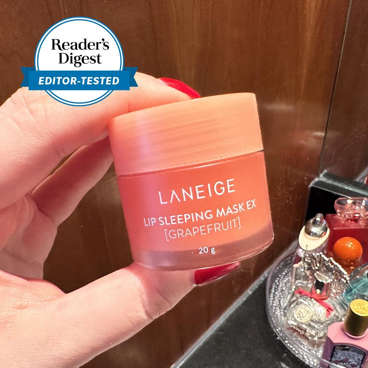 hand holding a bottle of Lip Sleep Mask