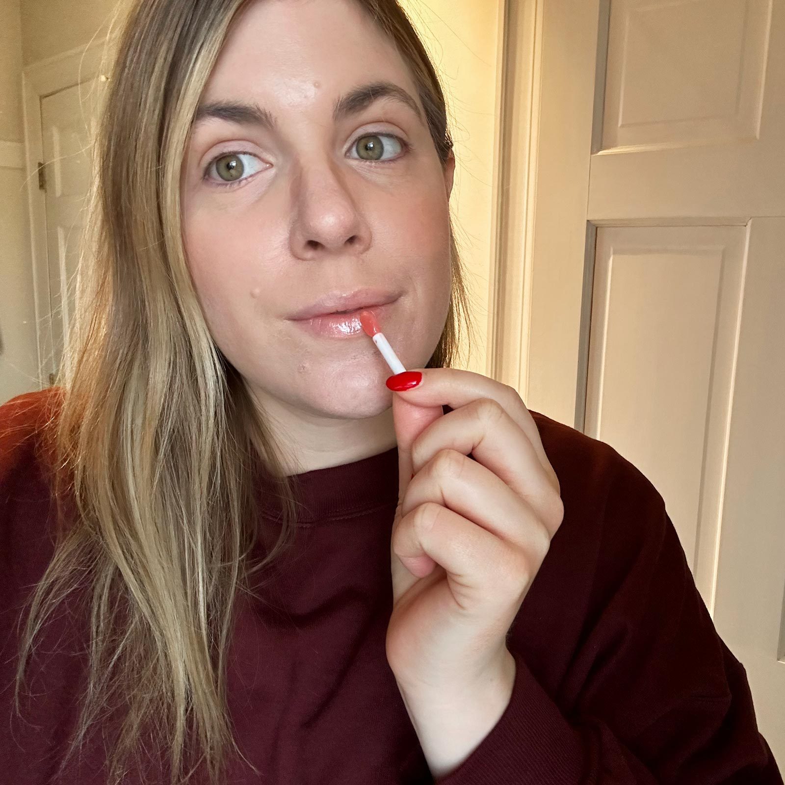 woman putting on lip sleep mask
