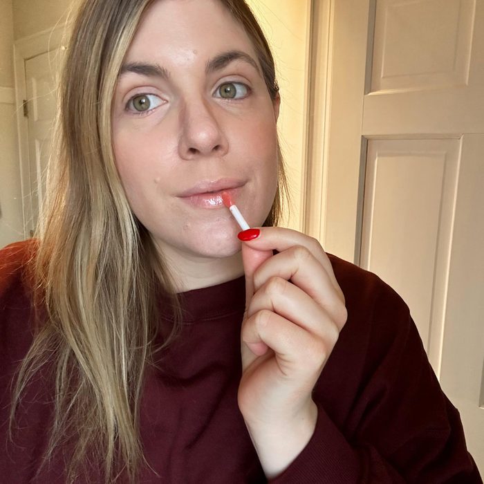 woman putting on lip sleep mask