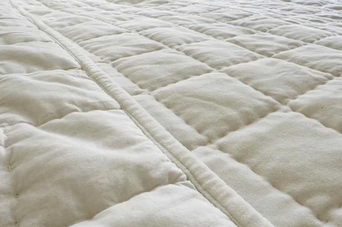 close up of a cream colored Quince quilt