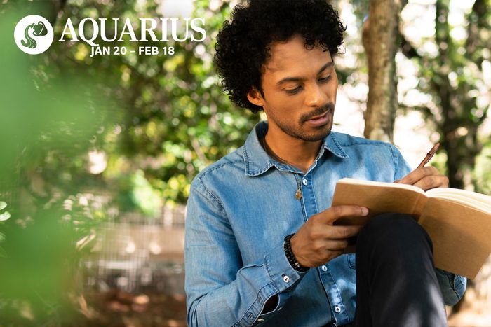man writing in his journal