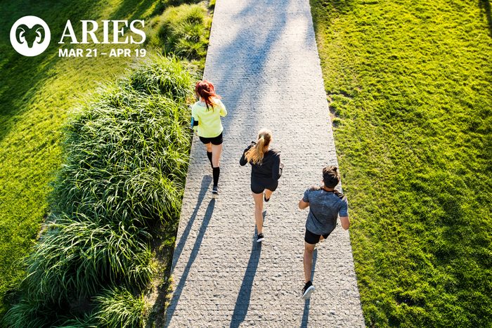 three people running, one in the lead