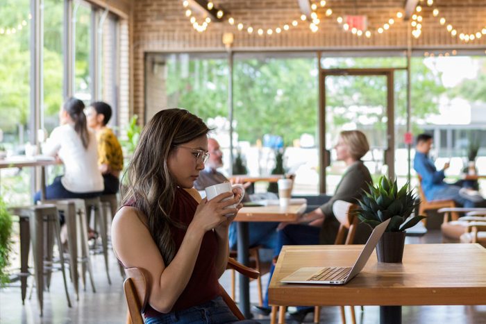 Businesswoman reviews document on laptop