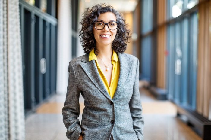 Smiling female entrepreneur outside auditorium