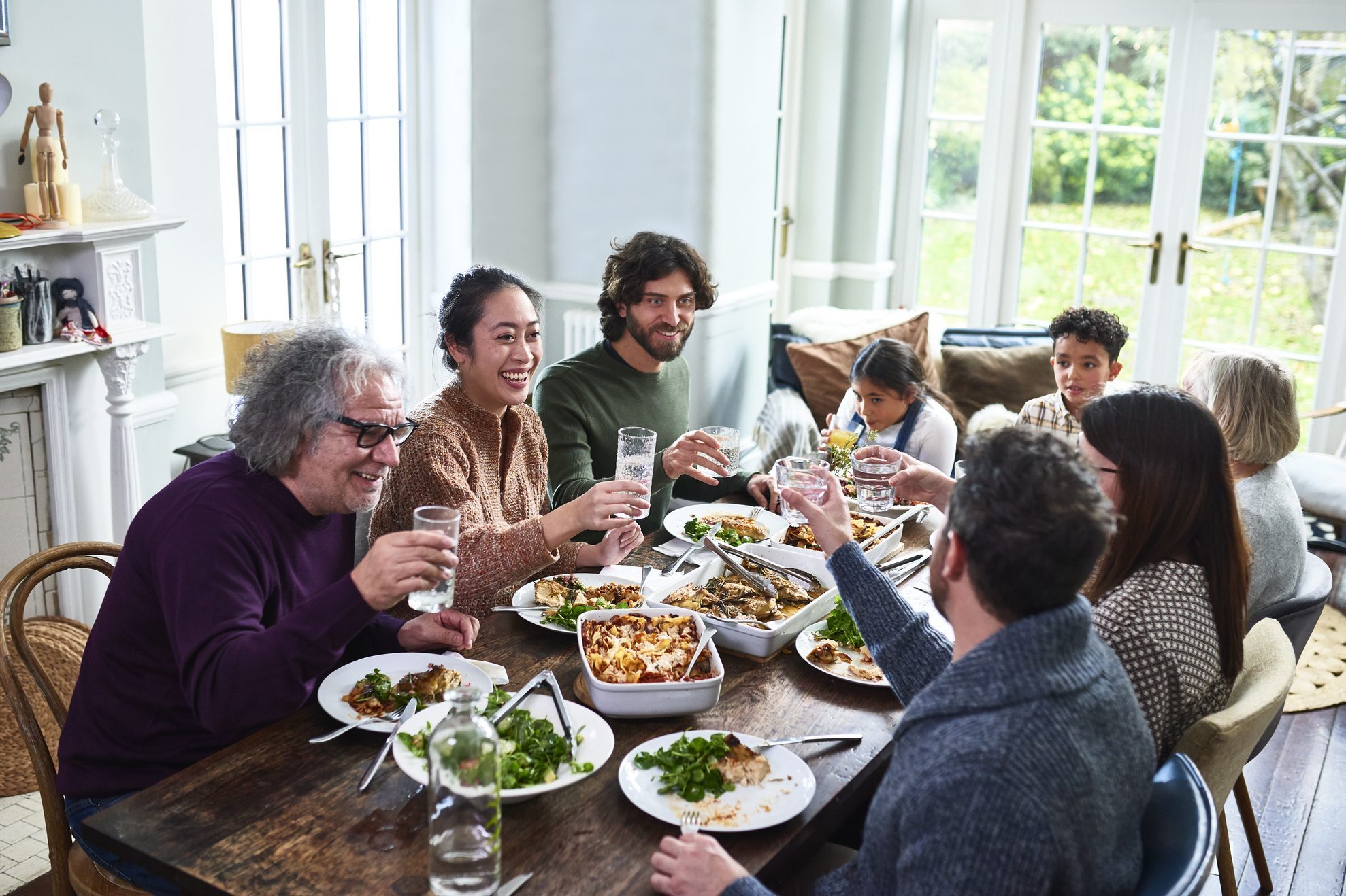 Extended family toasting drinks at lunch