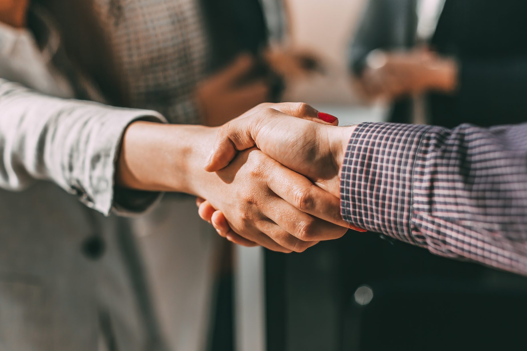 close up. young casual business people shaking hands with each