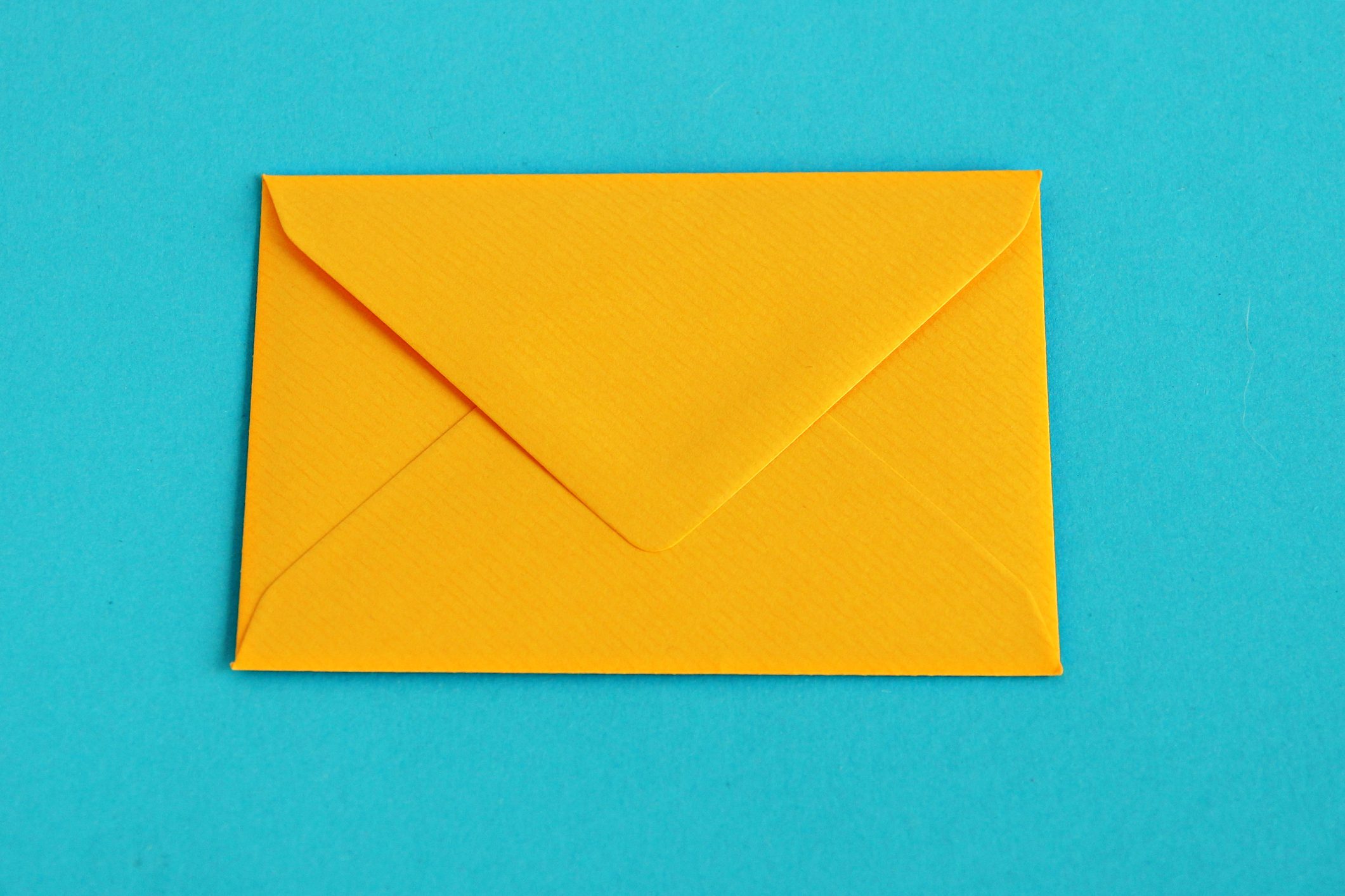 Yellow envelope over turquoise background