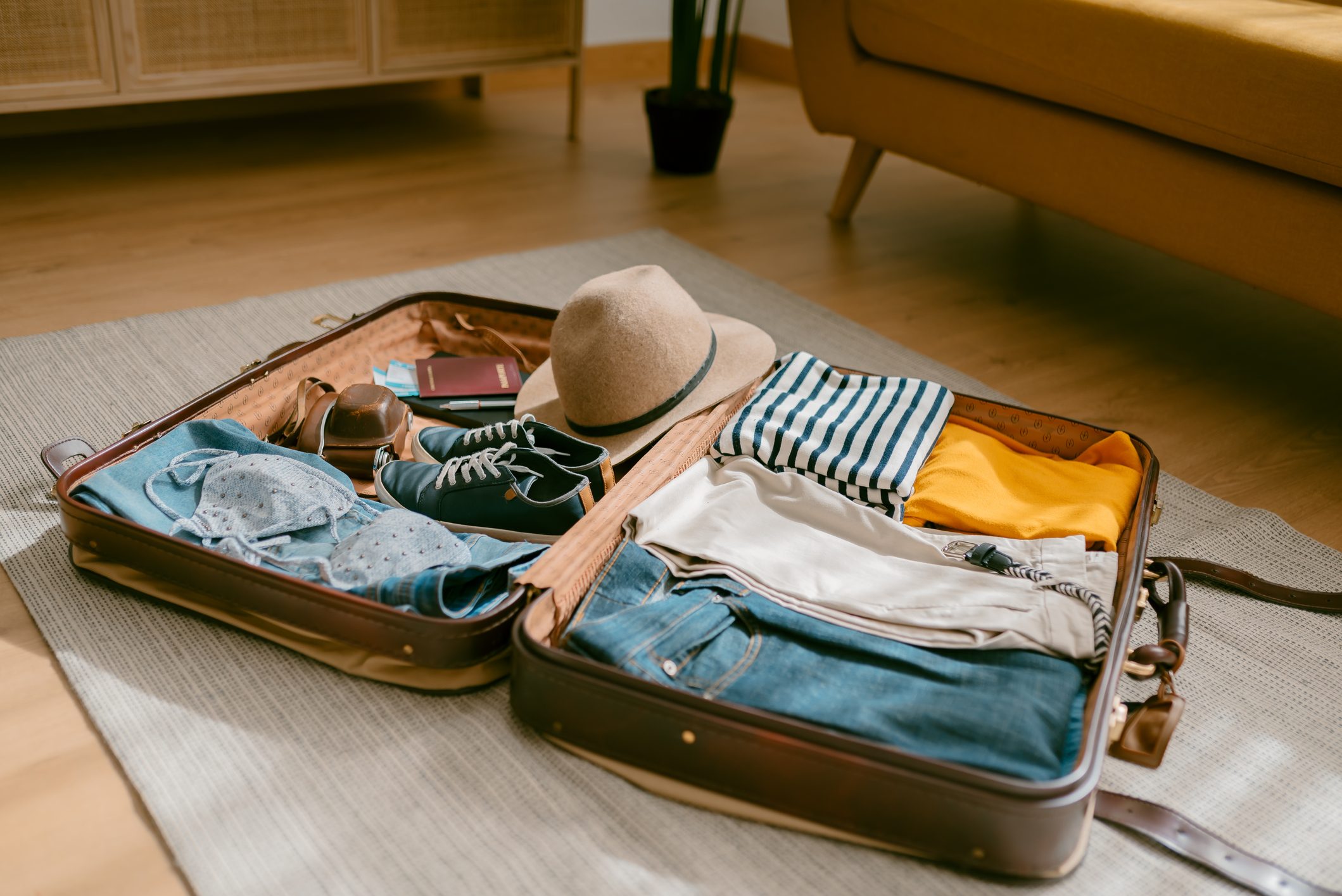Close-up view of an open suitcase full of clothes ready to travel.