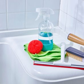 cleaning supplies arrange in a shower
