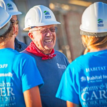 Jimmy Carter I na construction hat standing with other workers