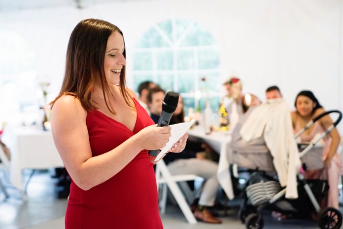Bridesmaid's speech at the table of honour at wedding reception.