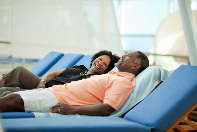 Mature couple on lounge chair on cruise ship