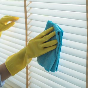 Midsection Of Woman Cleaning Window