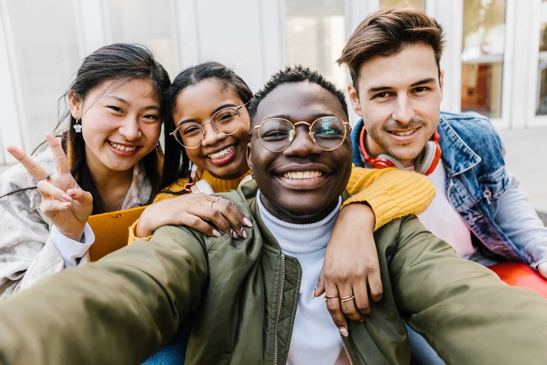 Self portrait of multiracial group of young student friends