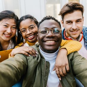 Self portrait of multiracial group of young student friends