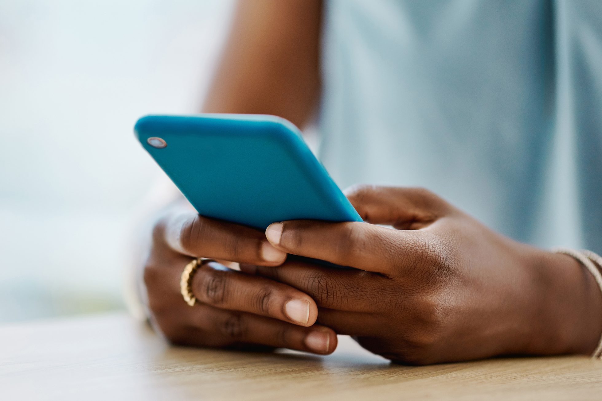African woman using a cellphone in an office alone