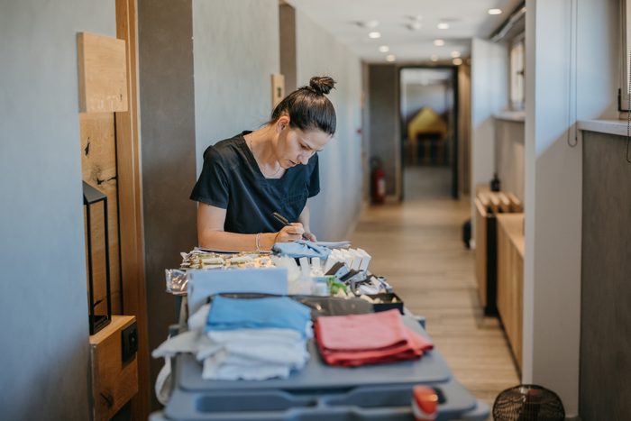Young hotel maid on work