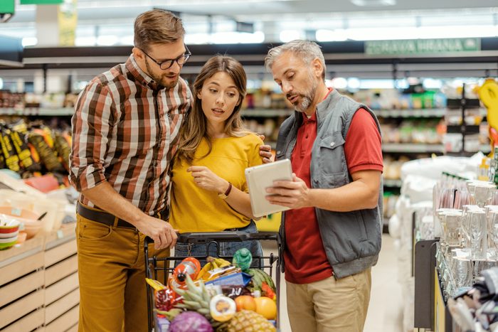 Couple Talking to Supermarket Worker