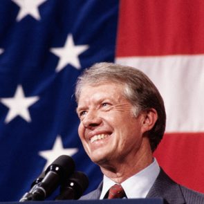 President Jimmy Carter at Podium during a town meeting with an American Flag Background