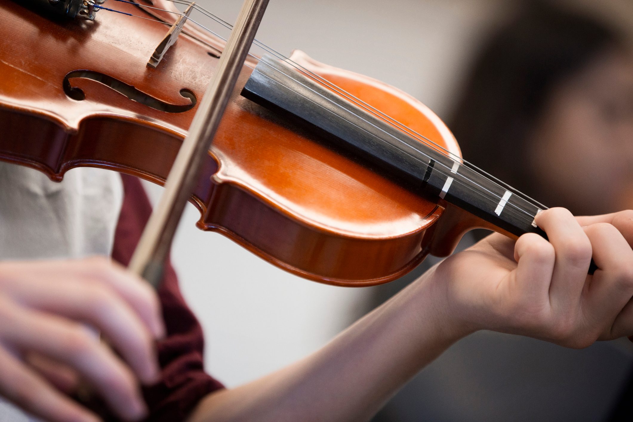 Caucasian student musician playing violin