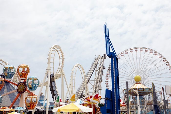 View of amusement park with rollercoaster and ferris wheel