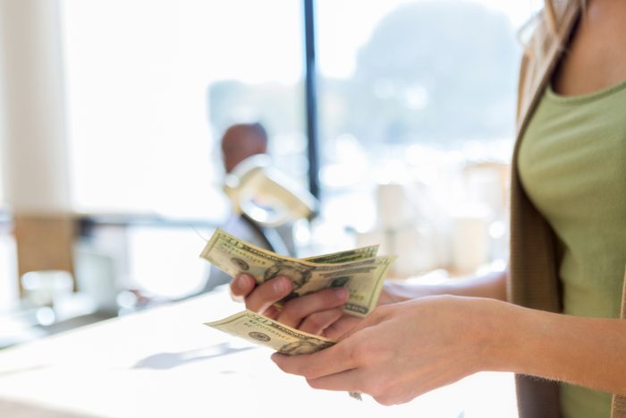 Restaurant waitress counting tips at the end of her shift