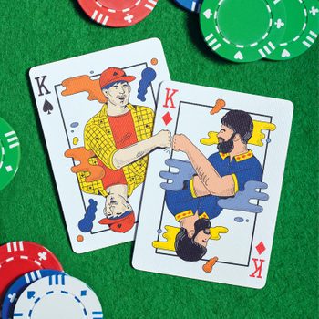 Playing cards with illustrations of two men giving each other a fist bump, with poker chips on a green poker table background