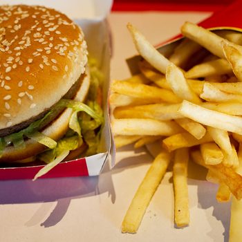 A Large Frency Fry and Big Mac Meal Rest on a Tray in a Mcdonald's fast food chain restaurant