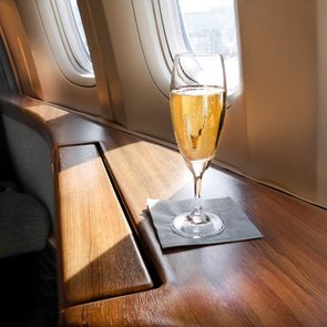 Glass of Welcoming Champagne Awaits a Passenger in First Class on an Airline Flight