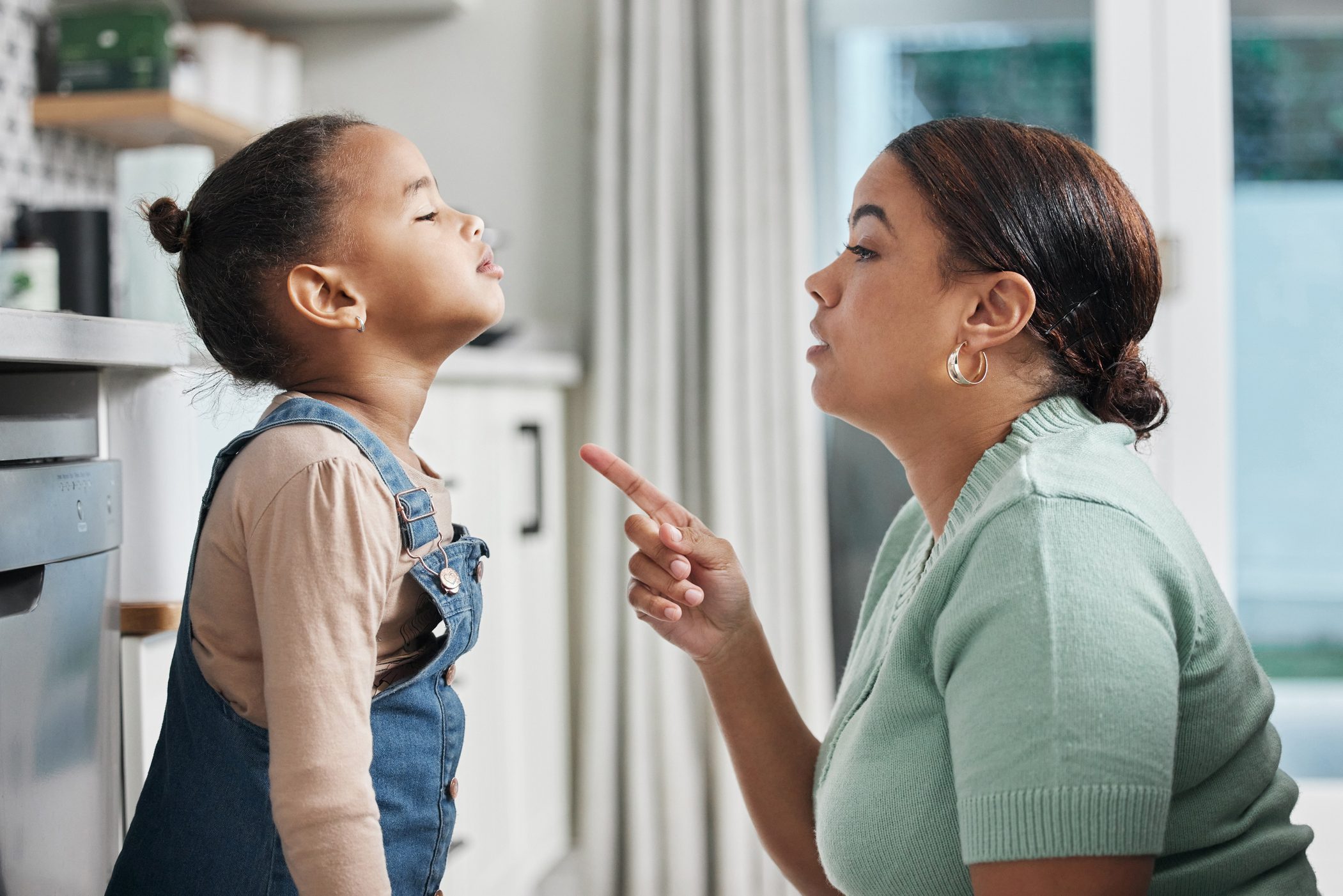 Shot of a little girl being spoken to sternly at home by her mother