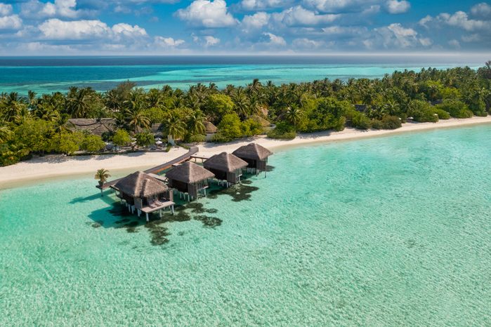 Maldives paradise scenery. Tropical aerial landscape, seascape with long jetty, water villas with amazing sea and lagoon beach, tropical nature. Exotic tourism destination banner, summer vacation