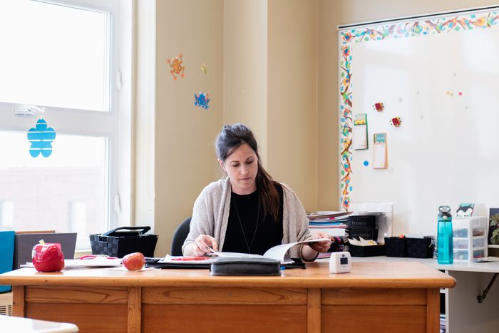 Teacher in a Classroom without students at school's out.