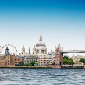 London montage against plain blue sky with River Thames in foreground