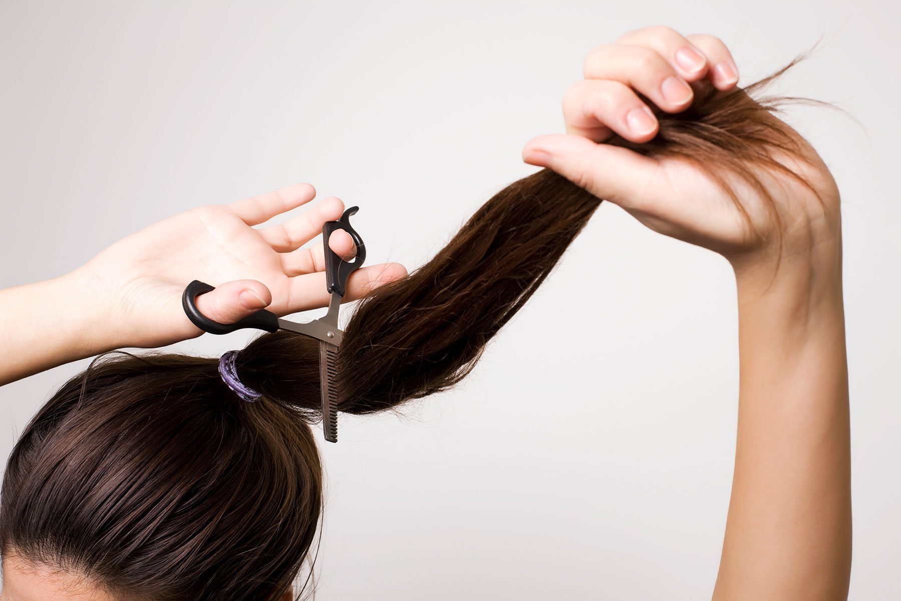 Woman Cutting Her Ponytail