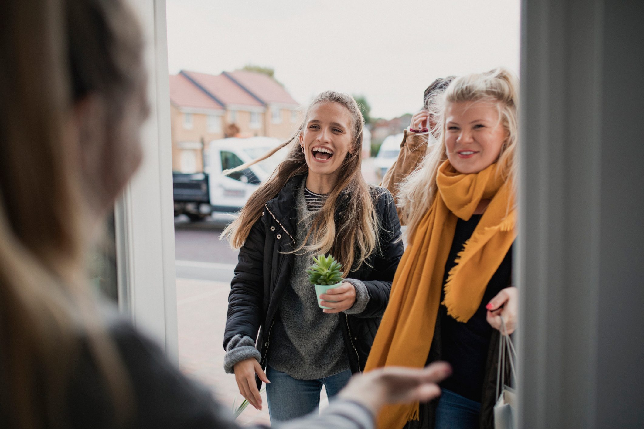 Greeting Guests at Housewarming Party