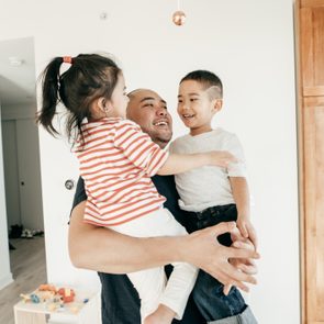 Dad hugging kids