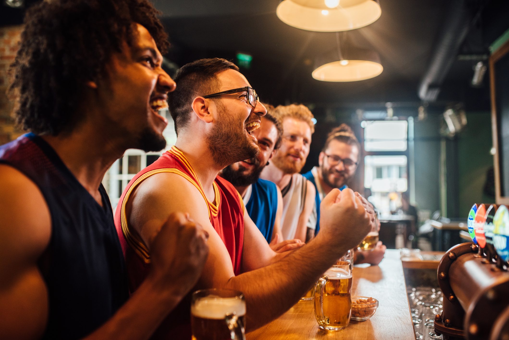 Men watching game and cheering