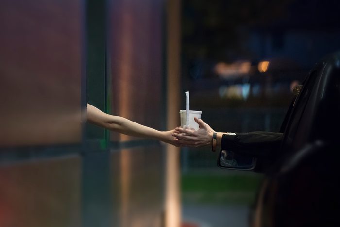 Customer Receiving Drinks at Drive Thru Restaurant