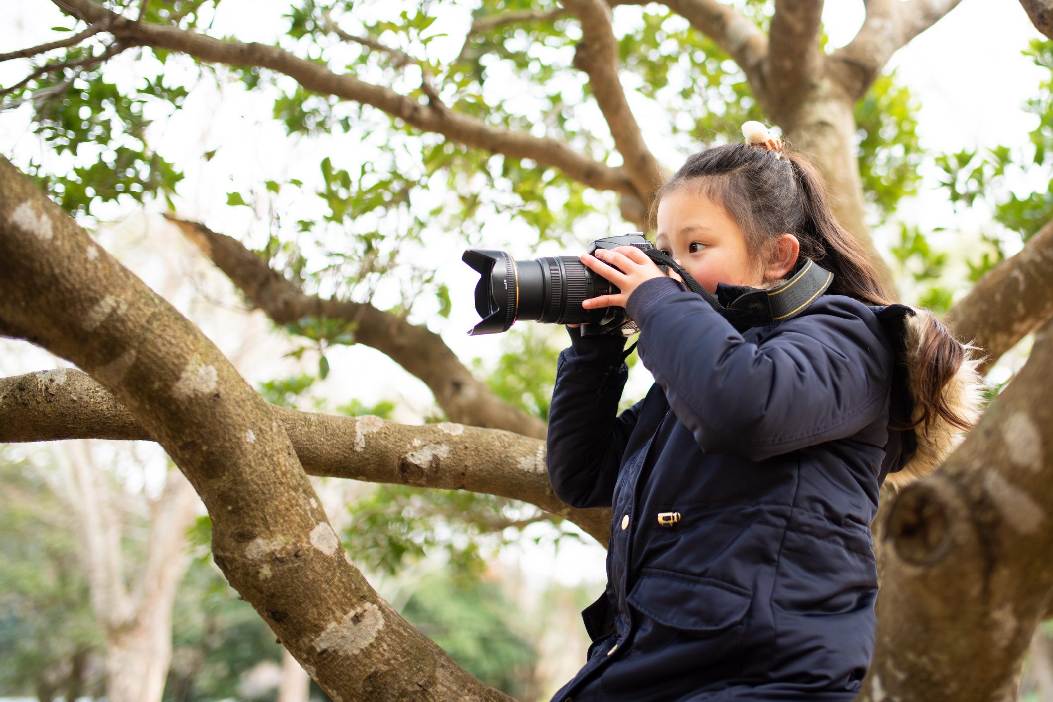 Girl taking a picture with an SLR camera