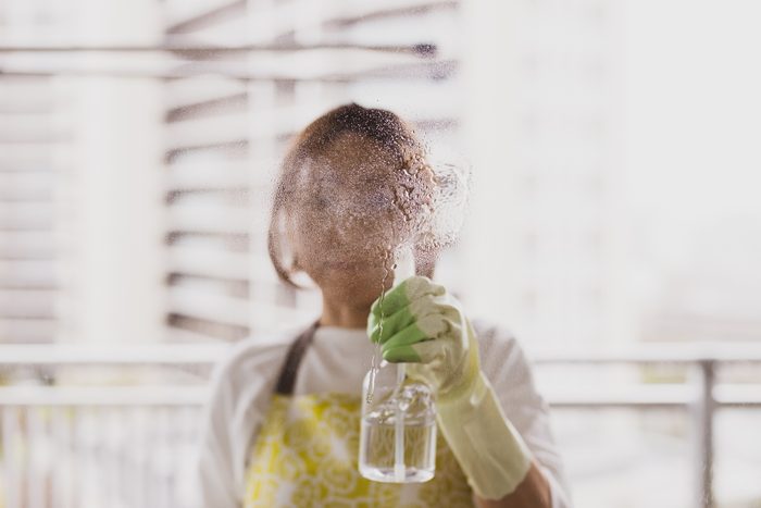 woman cleaning in the living room of her home.