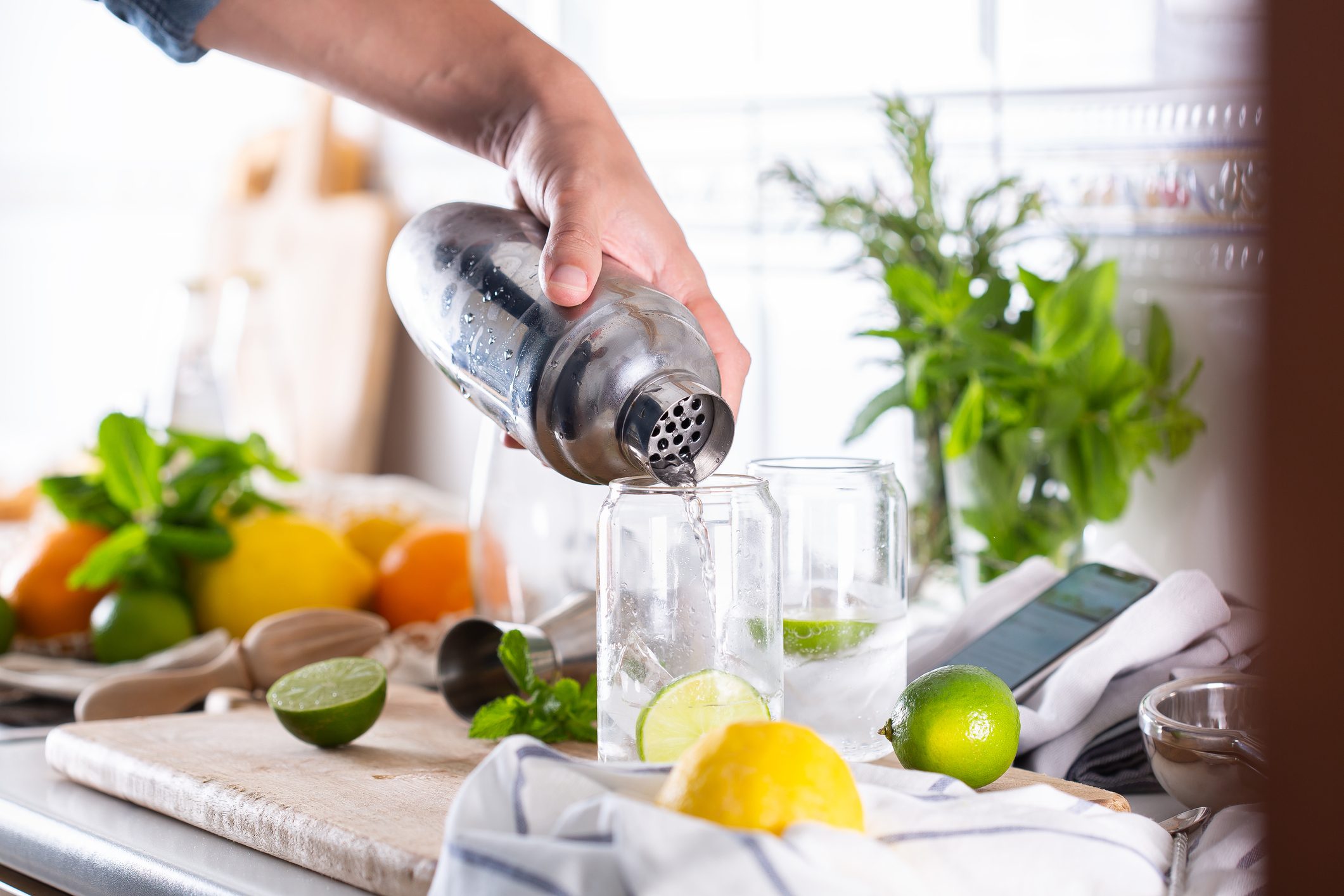 Mixologist making refreshing cocktail with hard seltzer at home
