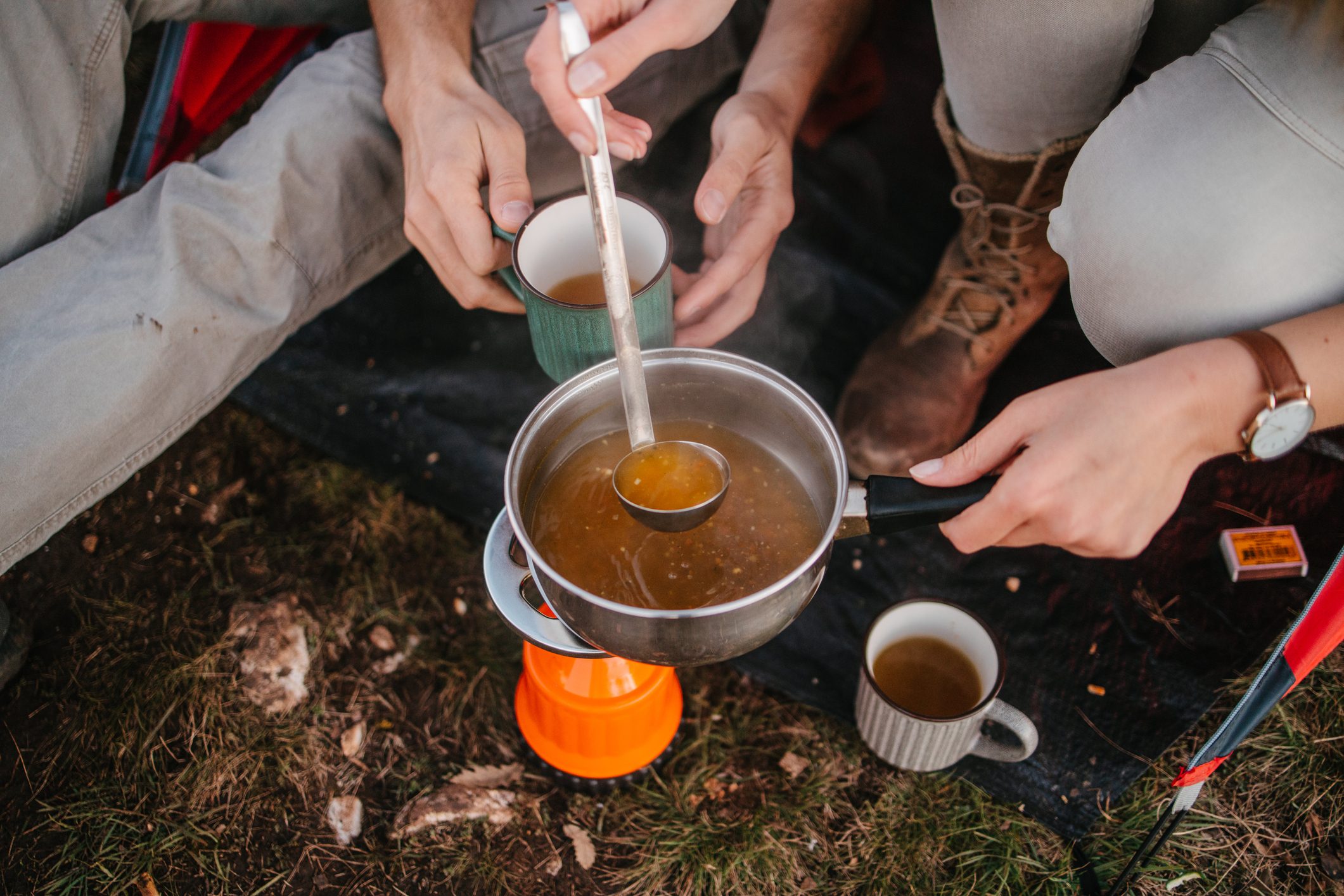 Pouring soup in a mug