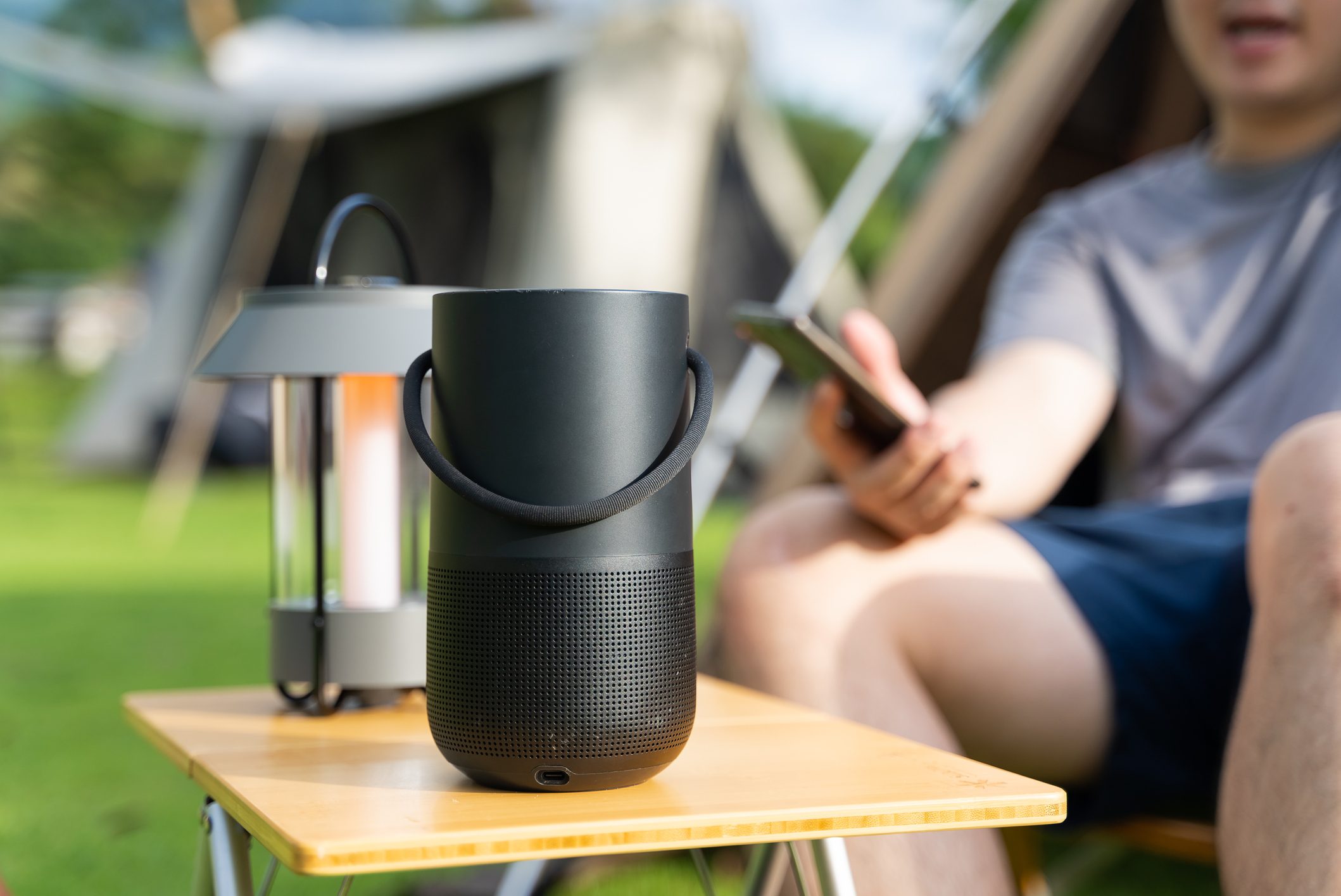 Asian man listening music enjoy summer camping at campsite