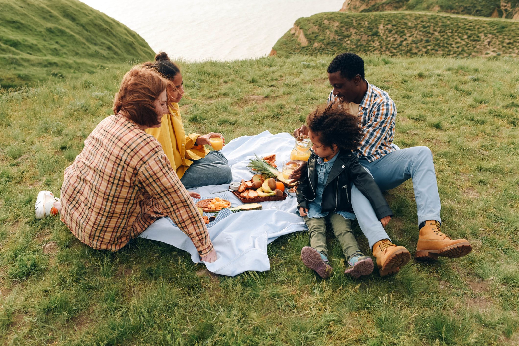 International family on a picnic in the background of nature.