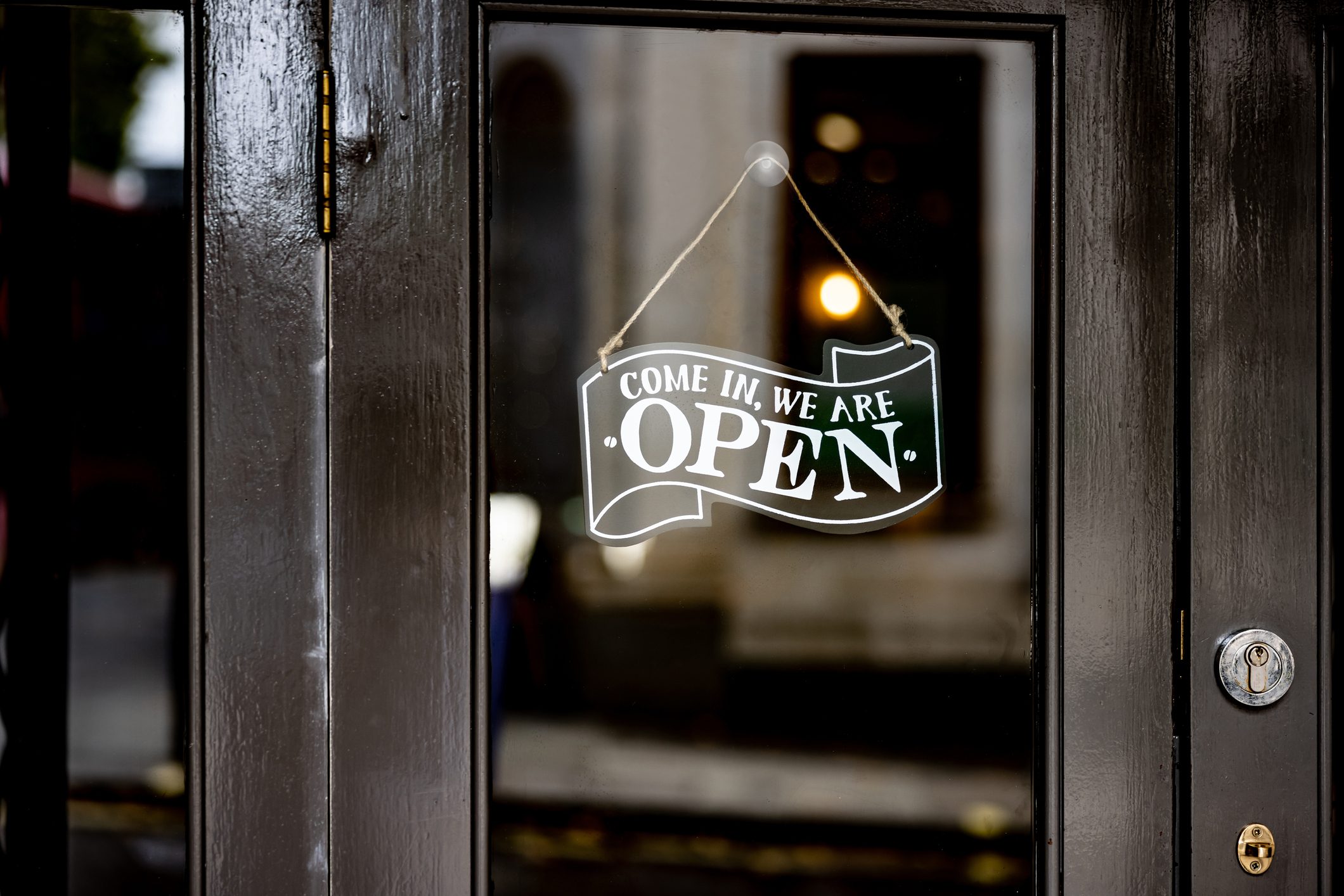 Open sign hanging on the door of a restaurant