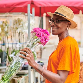 Woman shopping for flowers at an outdoor market