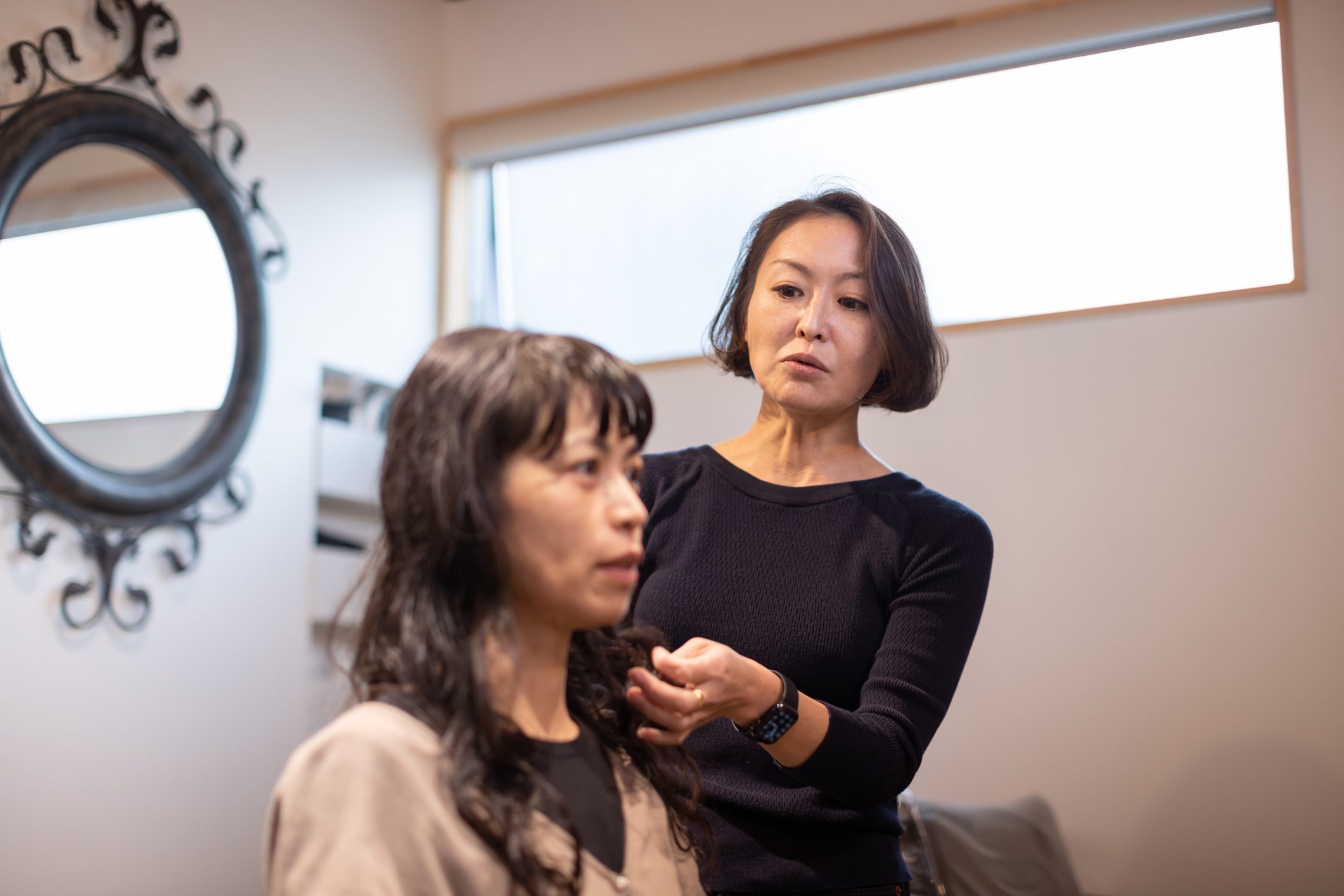 A woman getting a haircut at a private hair salon.